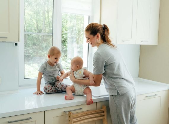 housewife-mom-spends-time-with-small-children-at-h-EHE4UFS.jpg