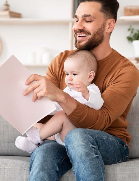 young-father-reading-book-for-little-baby-sitting-Q6YPRA5.jpg