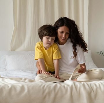 young-mother-read-book-together-with-small-son-bon-45FZPRH.jpg